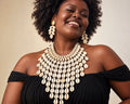 Cowrie disc drop earrings and bib necklace set worn